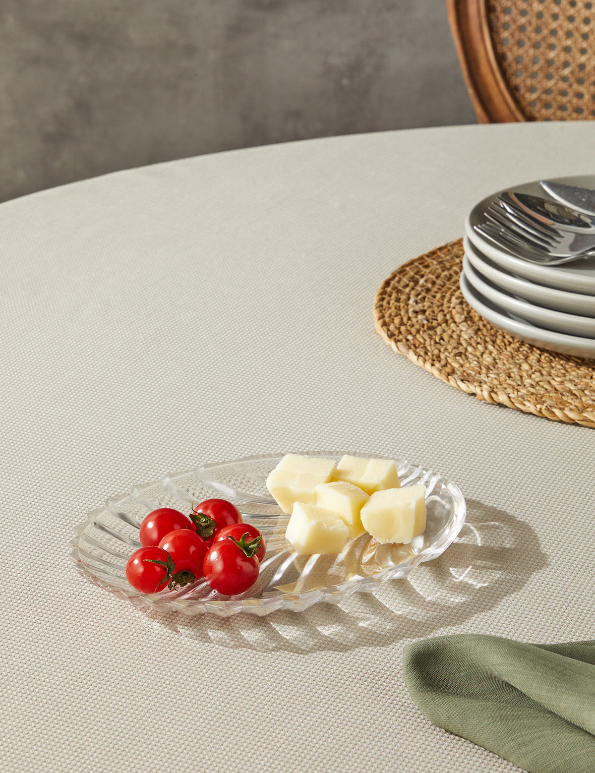 a plate of cheese and tomatoes on a table