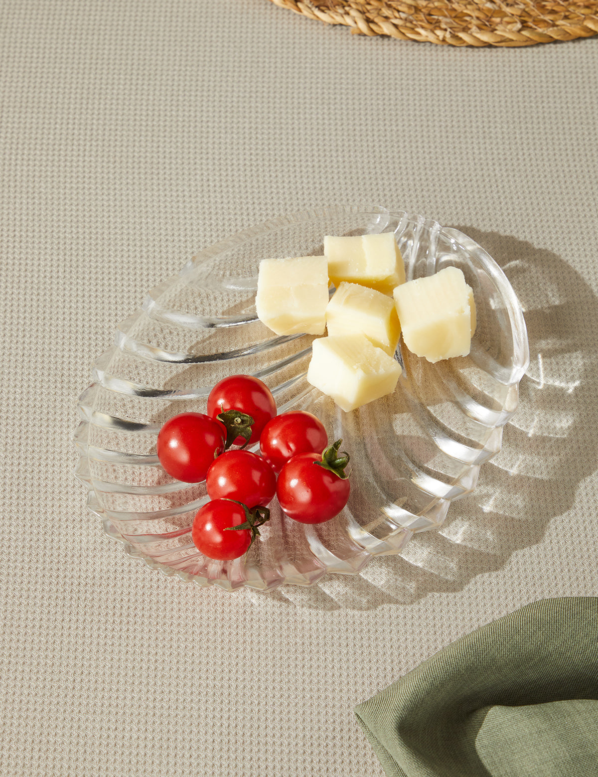 a plate of cheese and tomatoes on a table