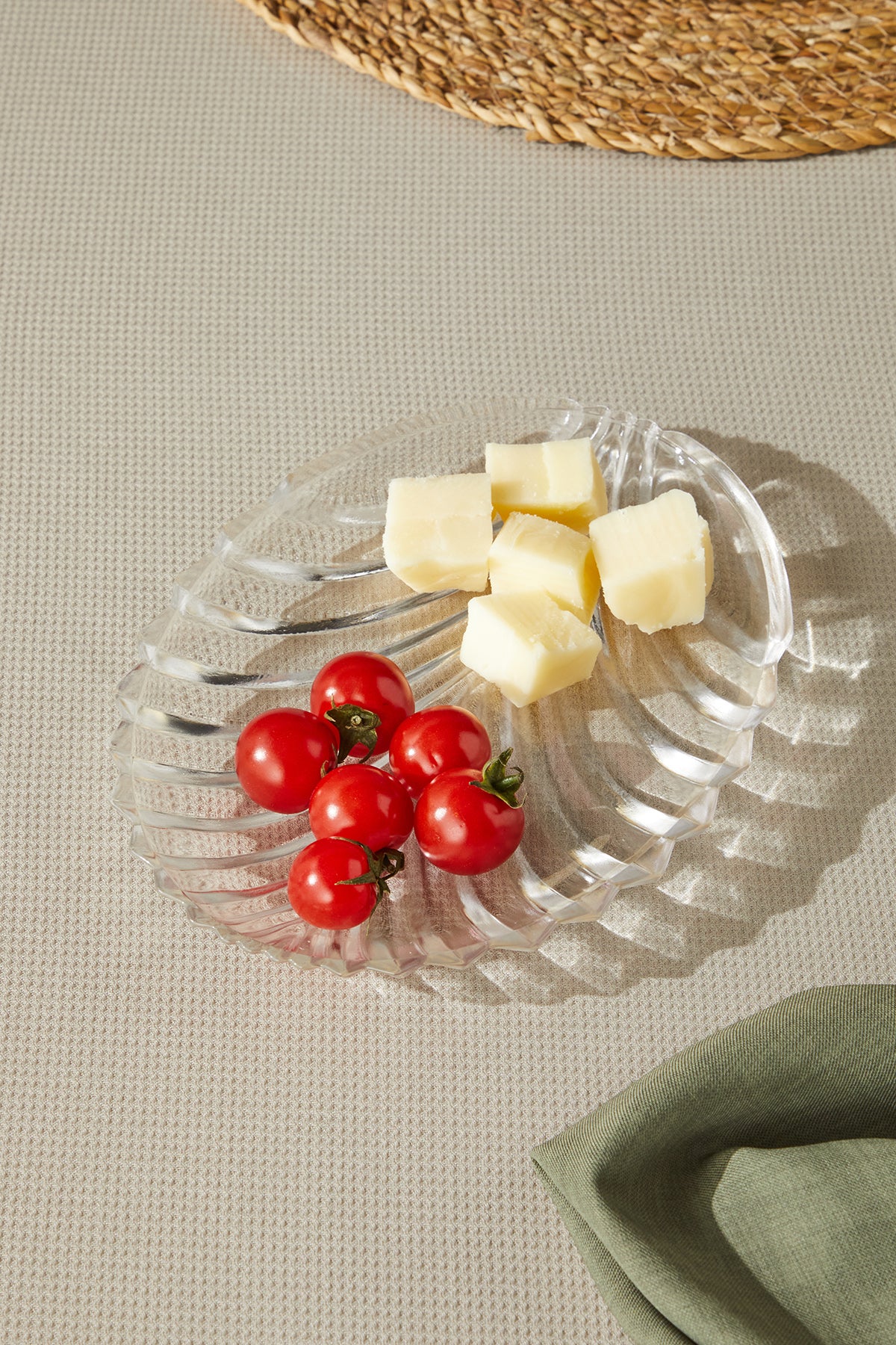 a plate of cheese and tomatoes on a table