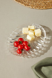 a plate of cheese and tomatoes on a table